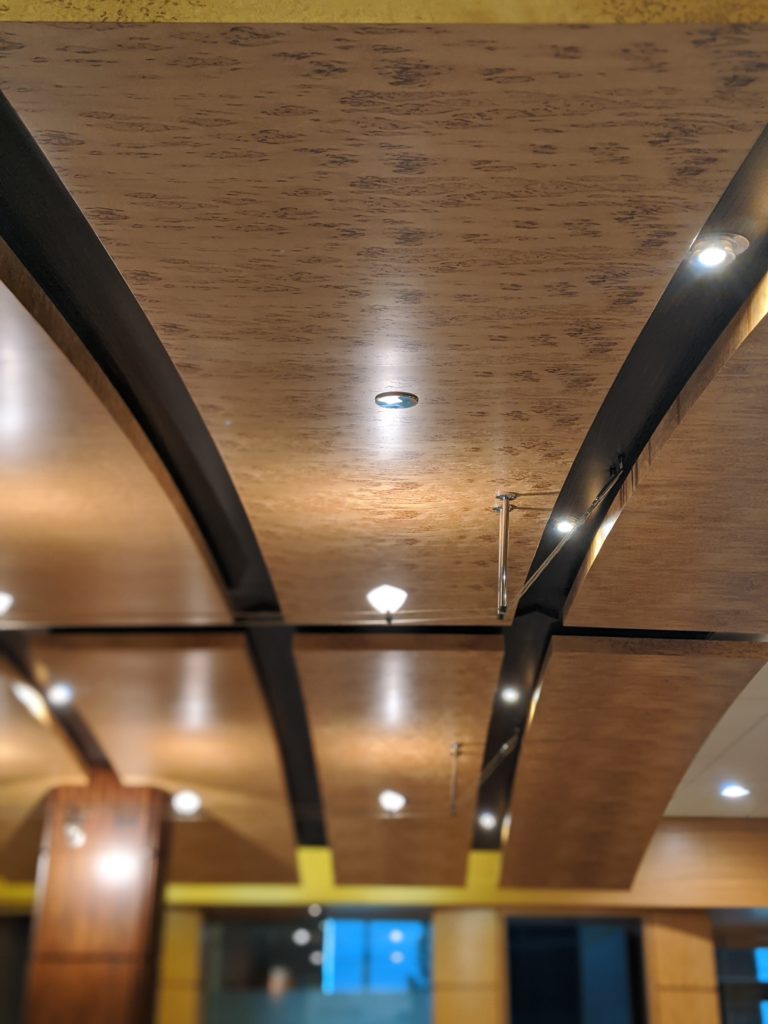 Carillian Birch Burl wood veneer arched ceiling panels application.