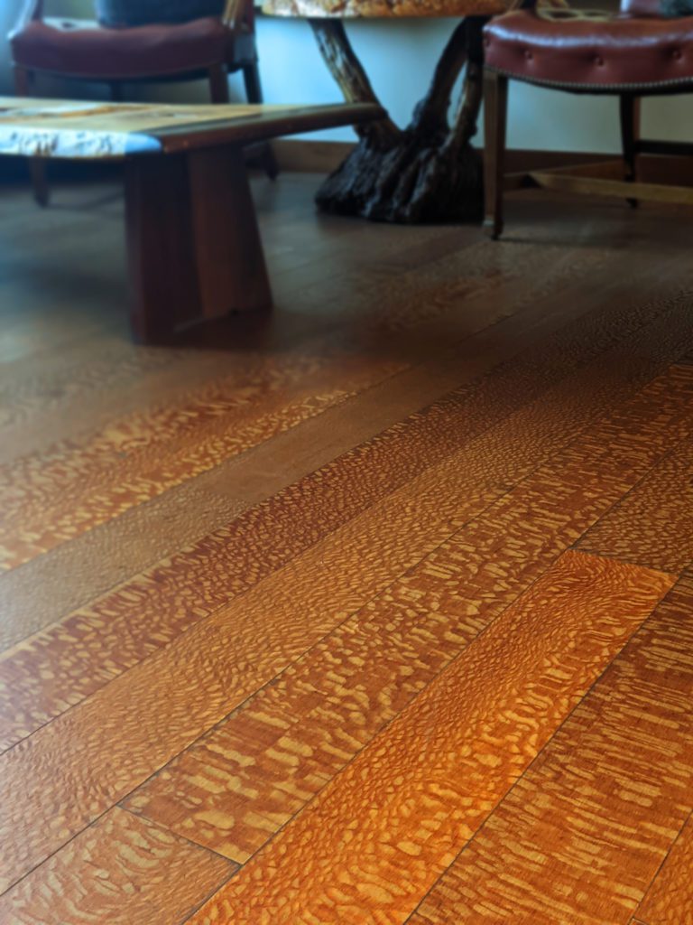 Close up photo of Brazilian Lacewood lumber used as flooring in Bohlke Veneer main office.